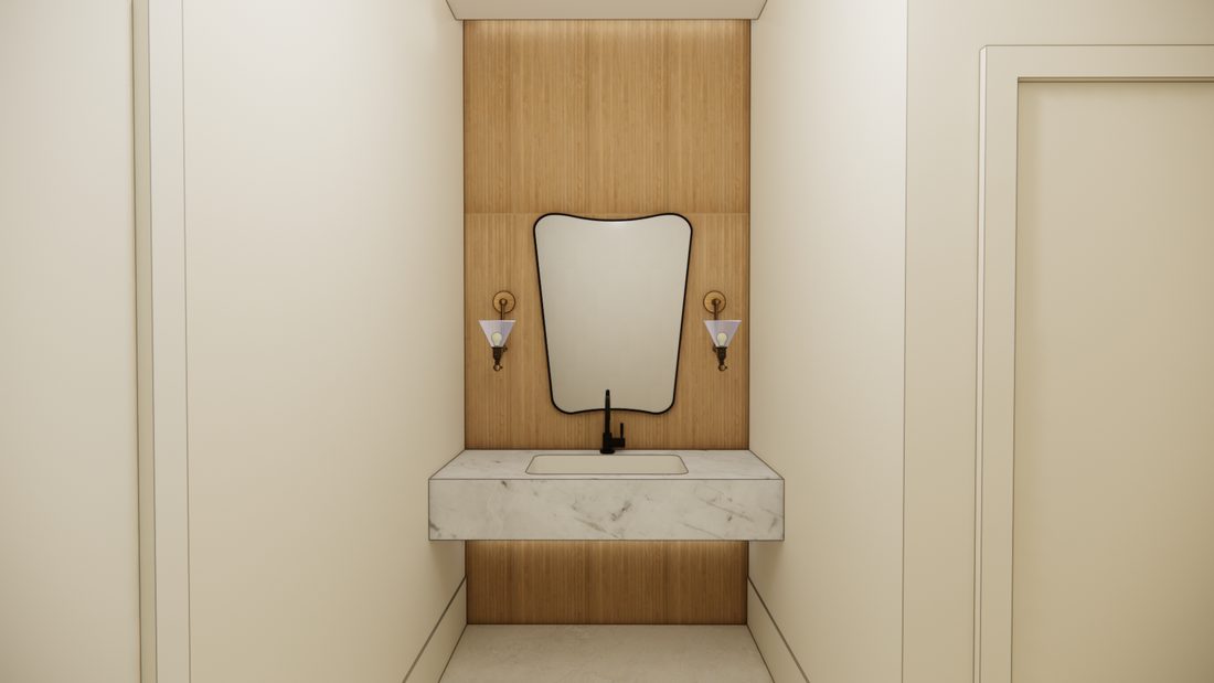 The women's restroom with a marble vanity, a shaped mirror, and brass wall sconces