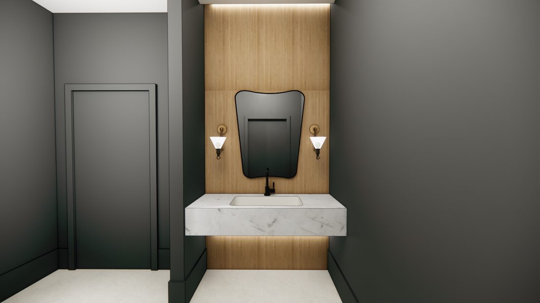 The men's restroom with a marble counter, a shaped mirror, and paneled walls