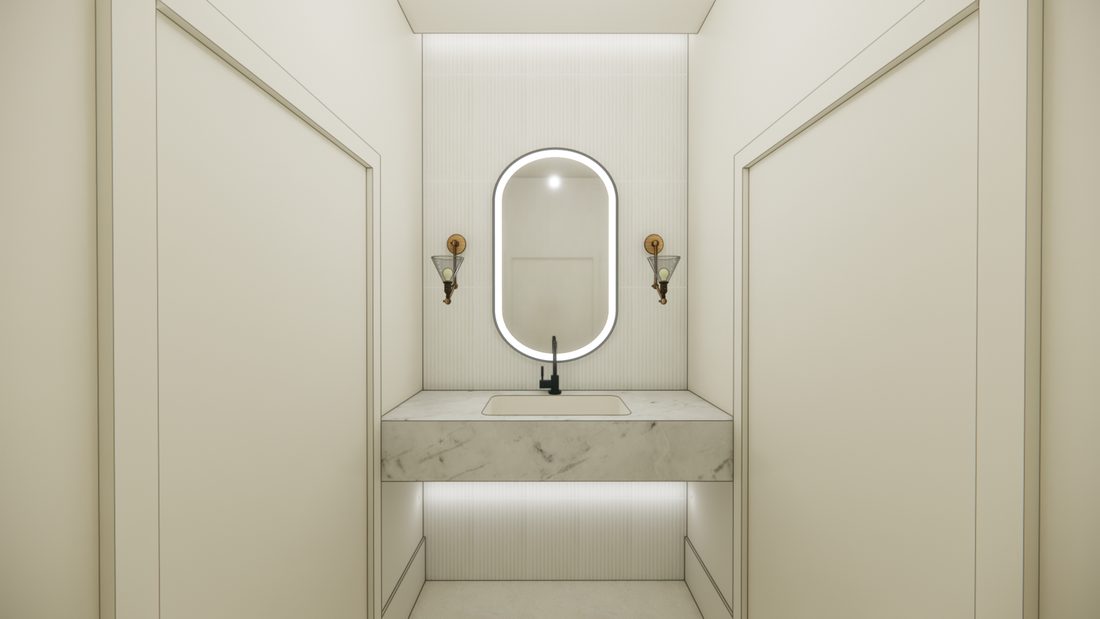 The restroom off the getting ready suites, with a lit oval mirror over a marble vanity